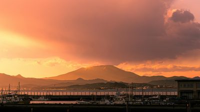 serene harbor view with majestic mountain at sunset