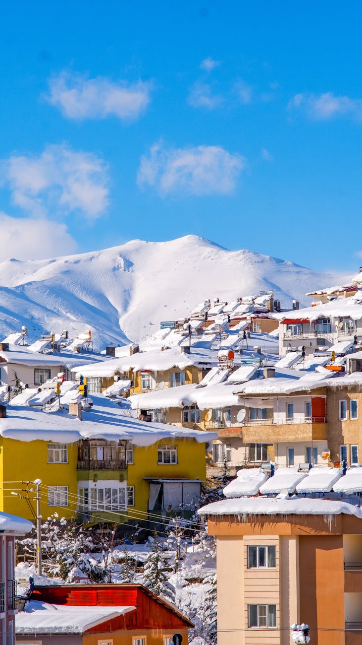 ski town in snow mountains under clear blue sky