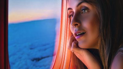 woman sitting by the window of an airplane