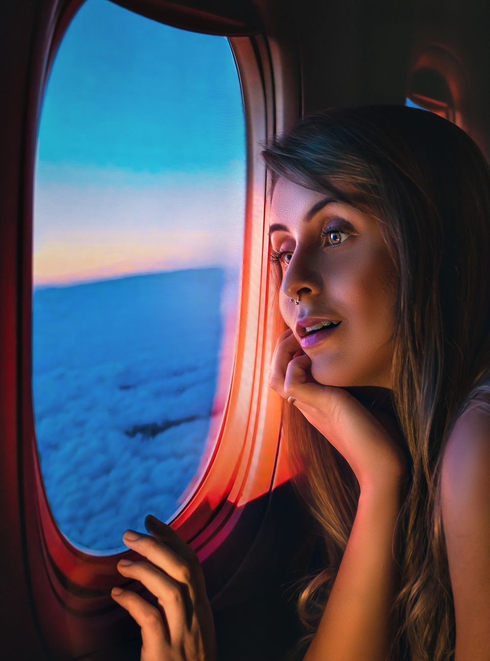 woman sitting by the window of an airplane