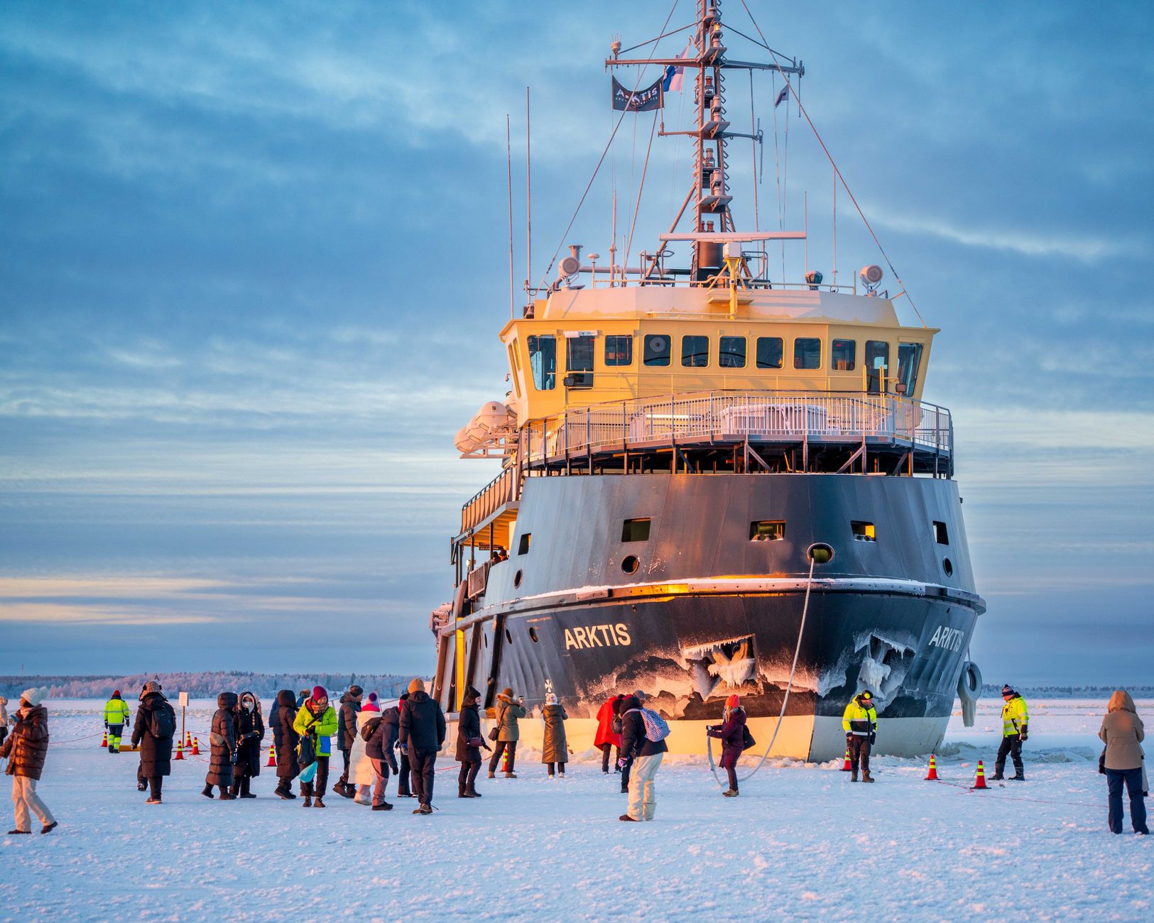 icebreaker ship docked on frozen sea with tourists