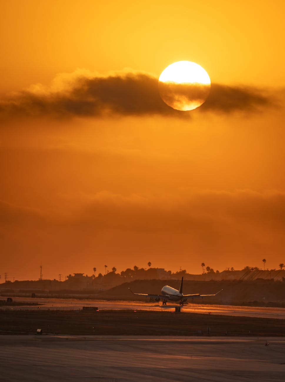 airplane landing at lax during vibrant sunset