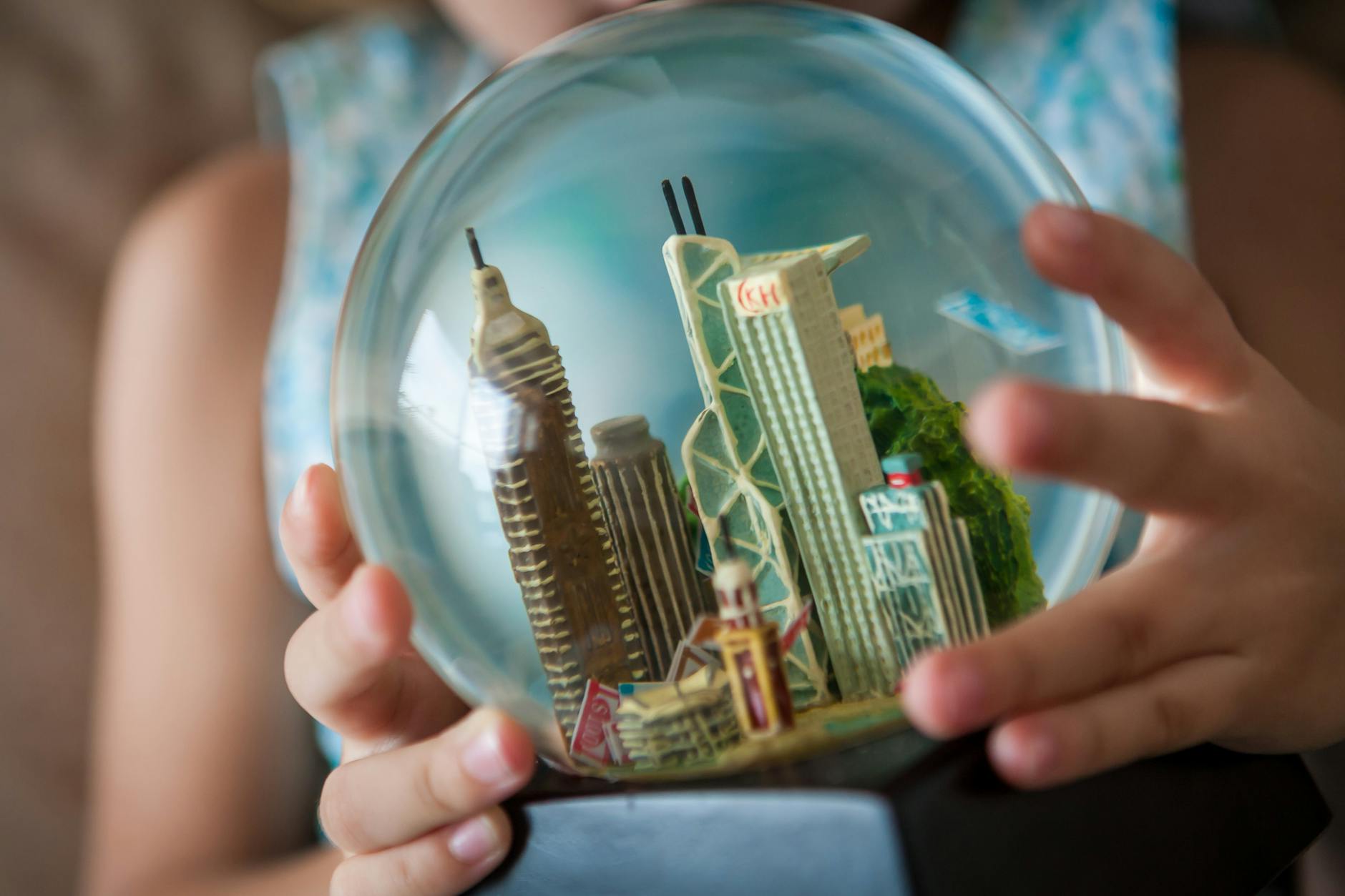 child holding hong kong skyline snow globe