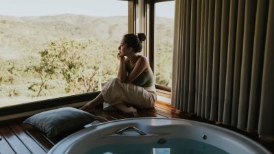 contemplative woman by jacuzzi with scenic view