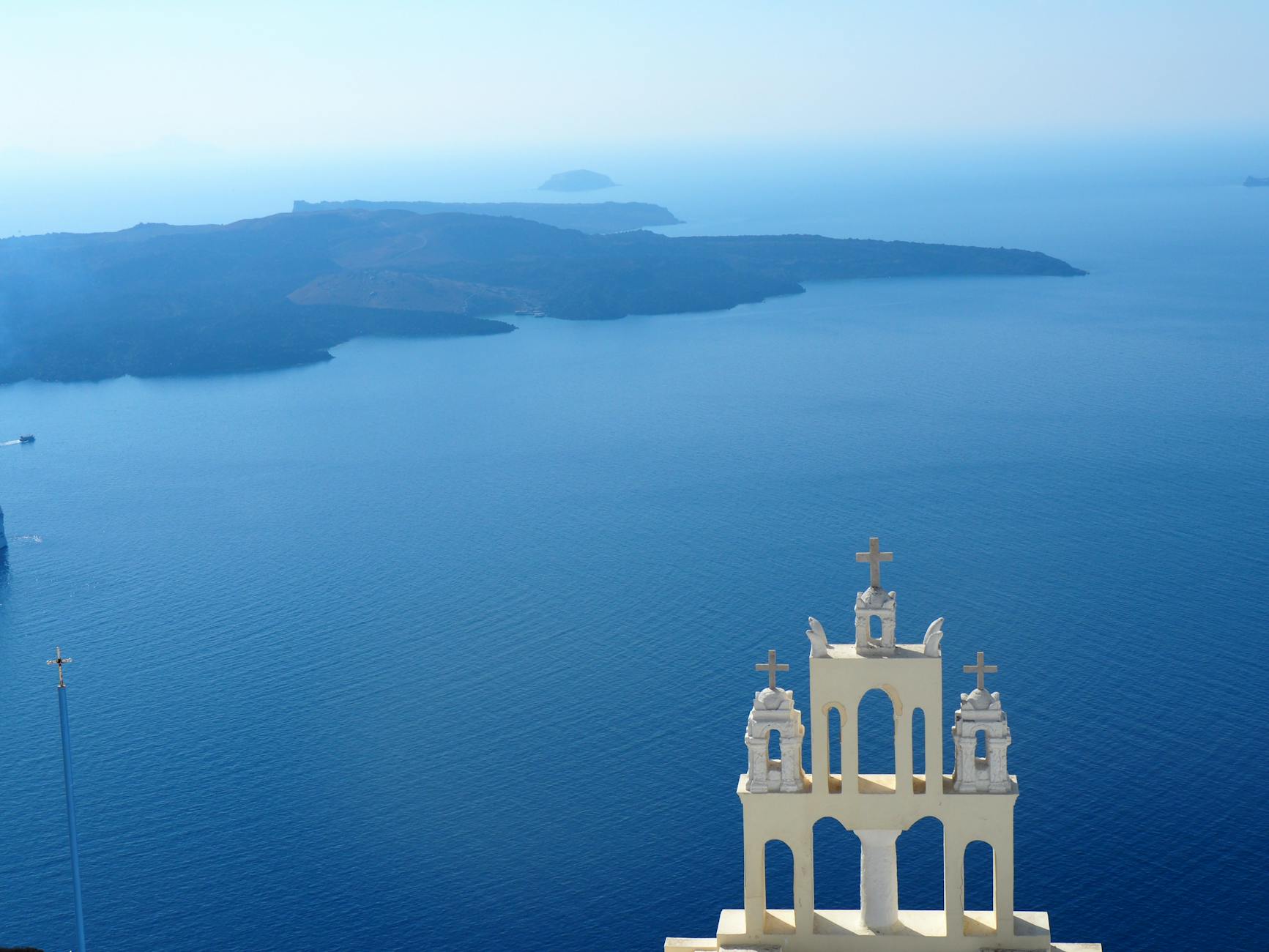 tower with crosses against island on lake