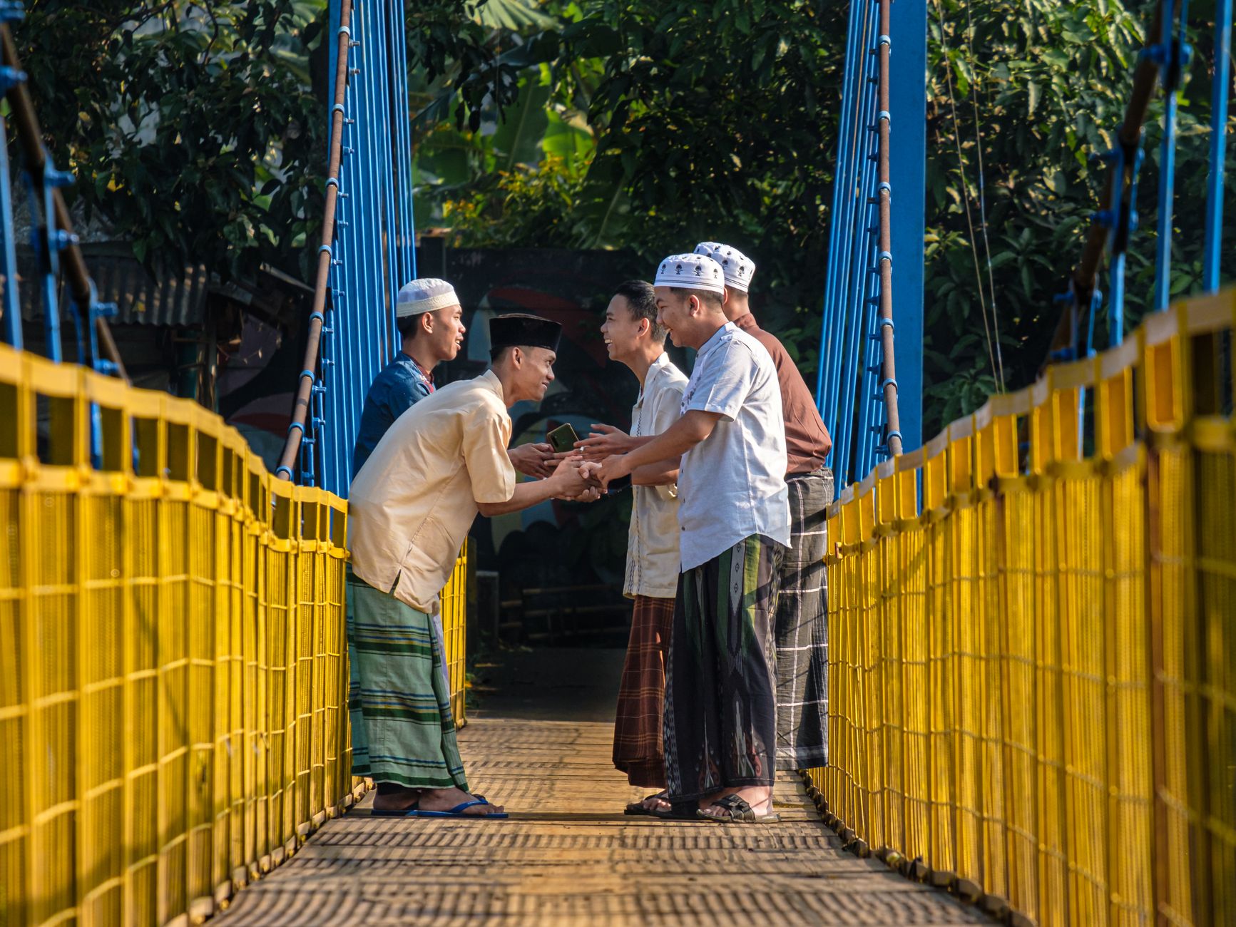 traditional greeting on indonesian suspension bridge