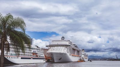 large cruise ships docked at a tropical port