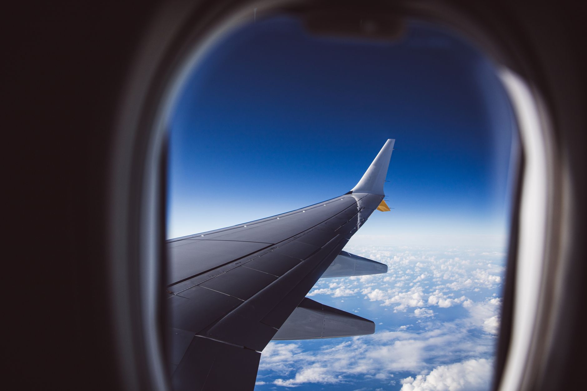 aerial view of clouds and airplane wing