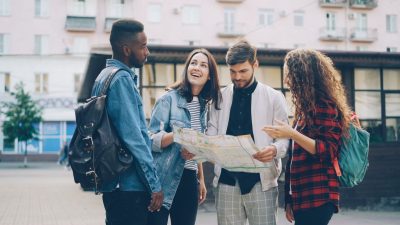 group of friends exploring city with map