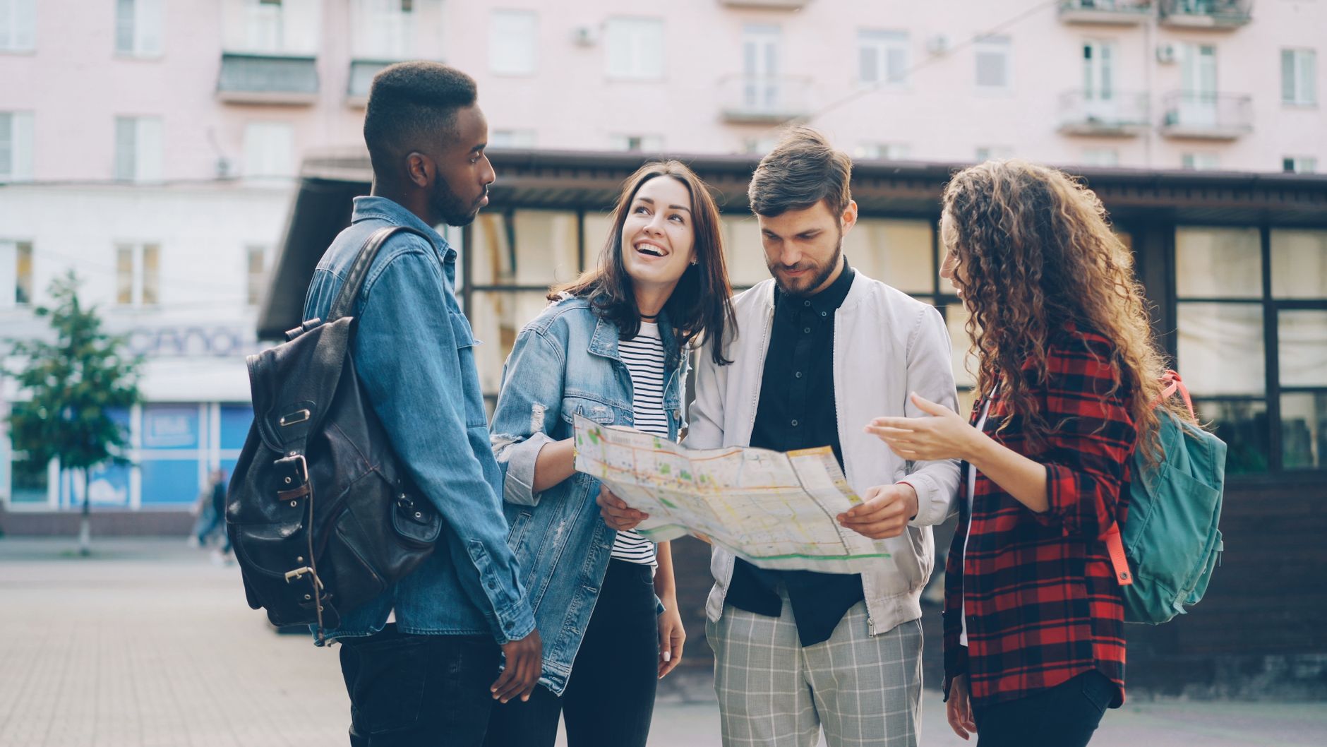 group of friends exploring city with map