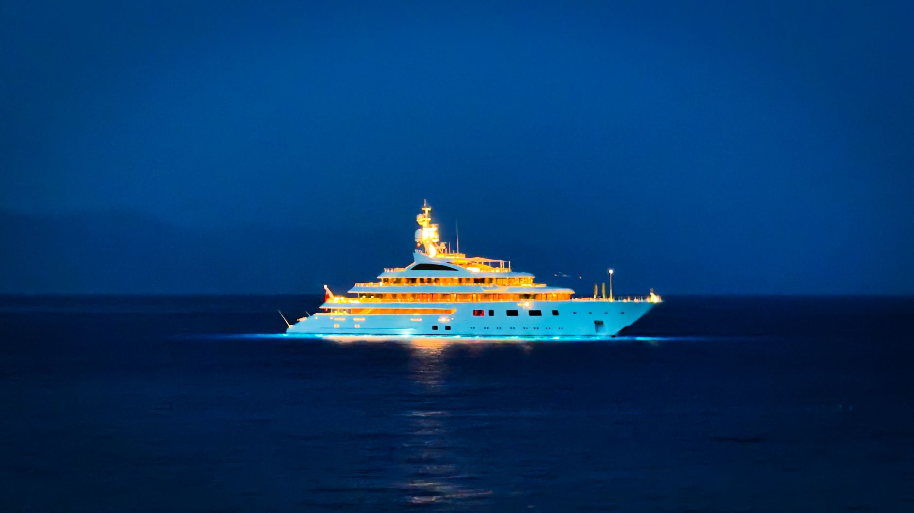 luxurious yacht sailing at night on ocean