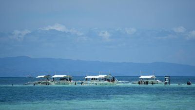 tropical boats on clear blue waters in the philippines
