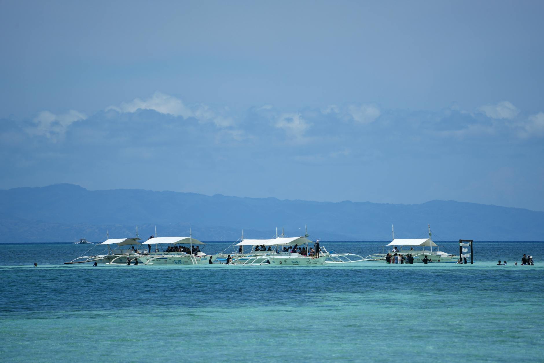tropical boats on clear blue waters in the philippines