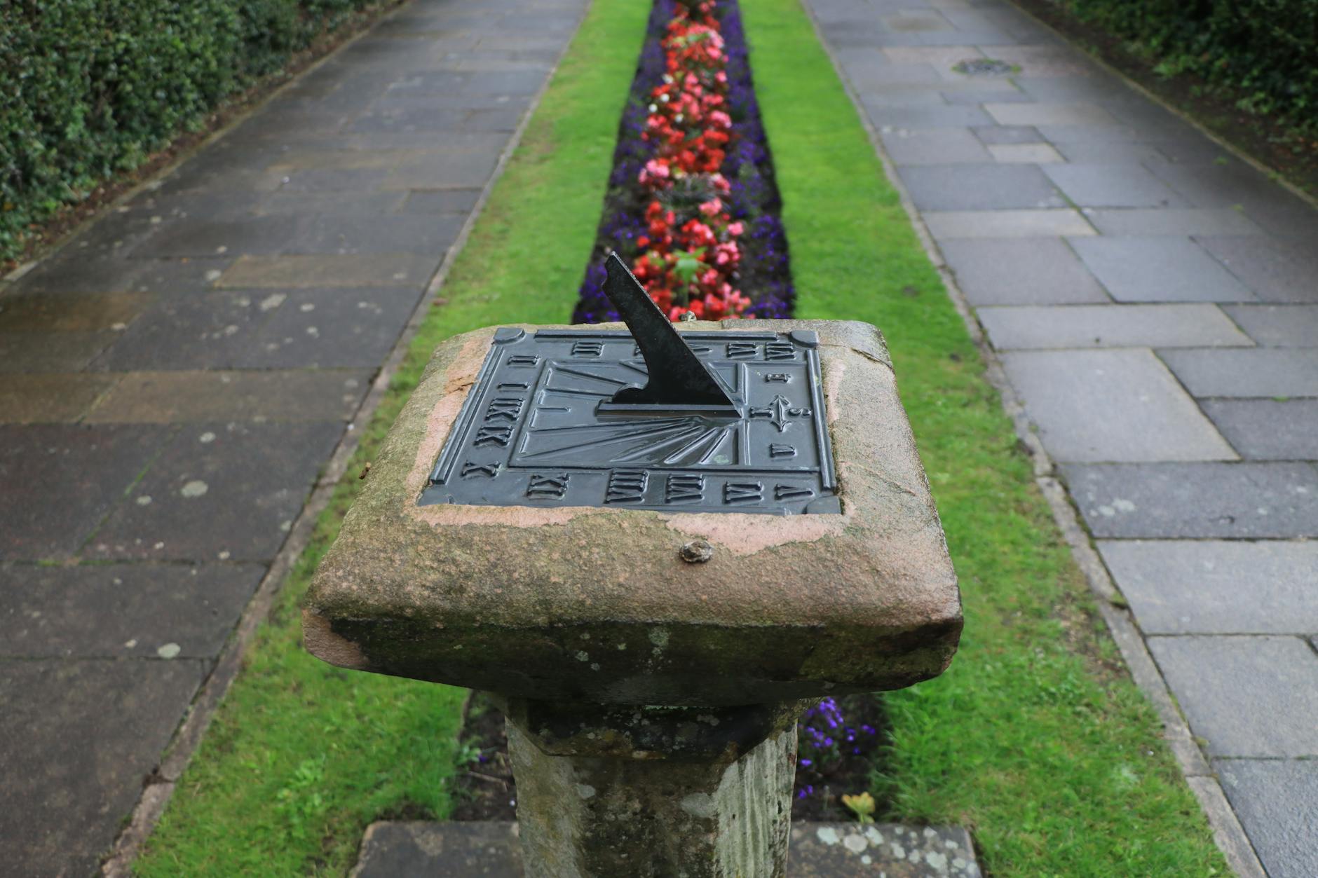 ancient sundial in garden pathway england