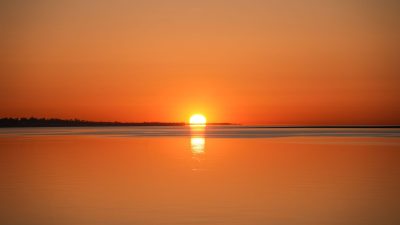 serene ocean sunrise with a golden reflection