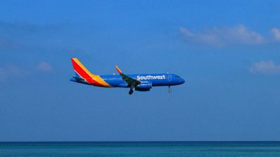 airliner soars over tropical beach in saint martin