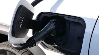 electric vehicle charging close up in sunlight