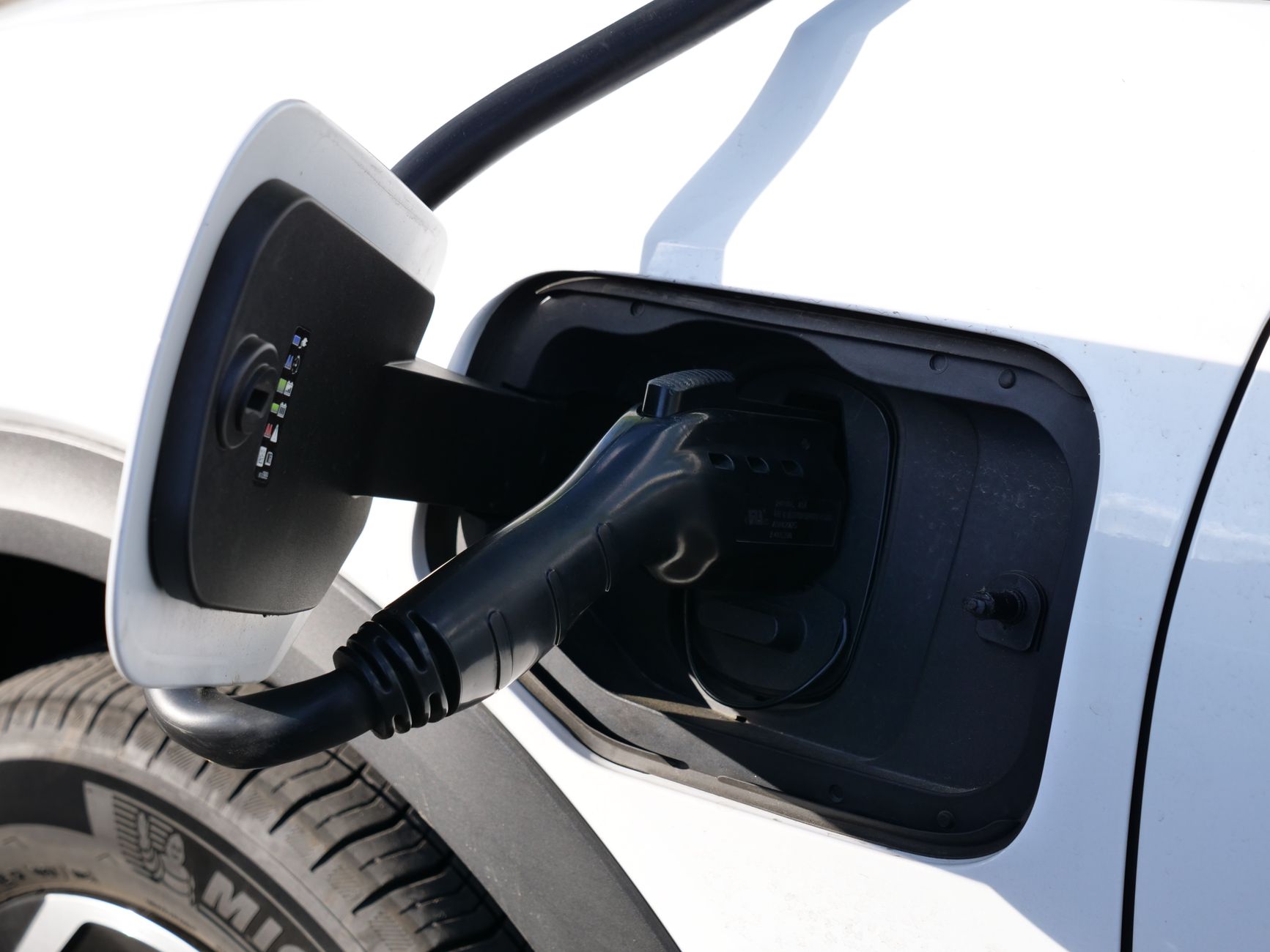 electric vehicle charging close up in sunlight