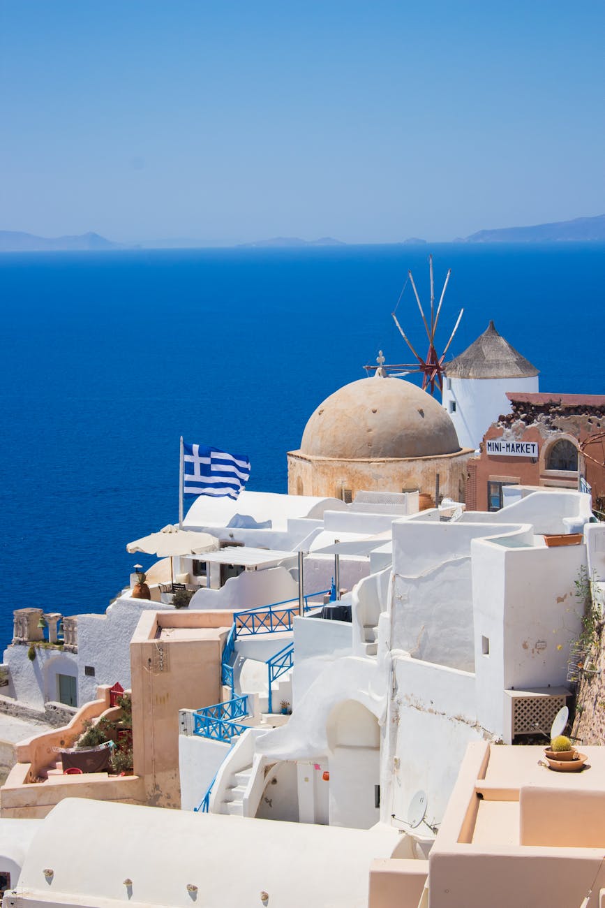 white and brown concrete building near body of water