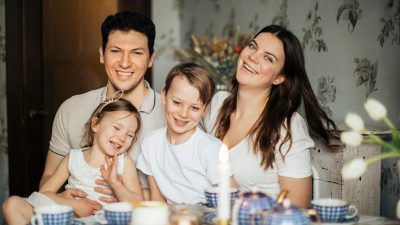 loving family laughing at table having cozy meal