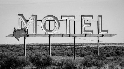 grayscale photo of motel signage
