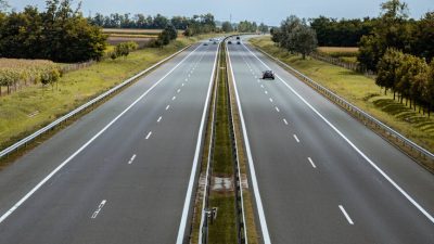 photo of expressway under cloudy sky