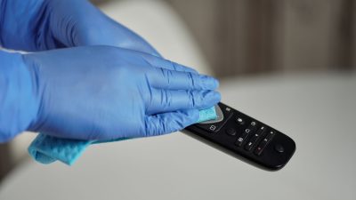 person holding black remote control