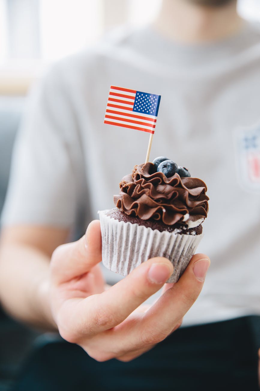 photo of man holding a cupcake