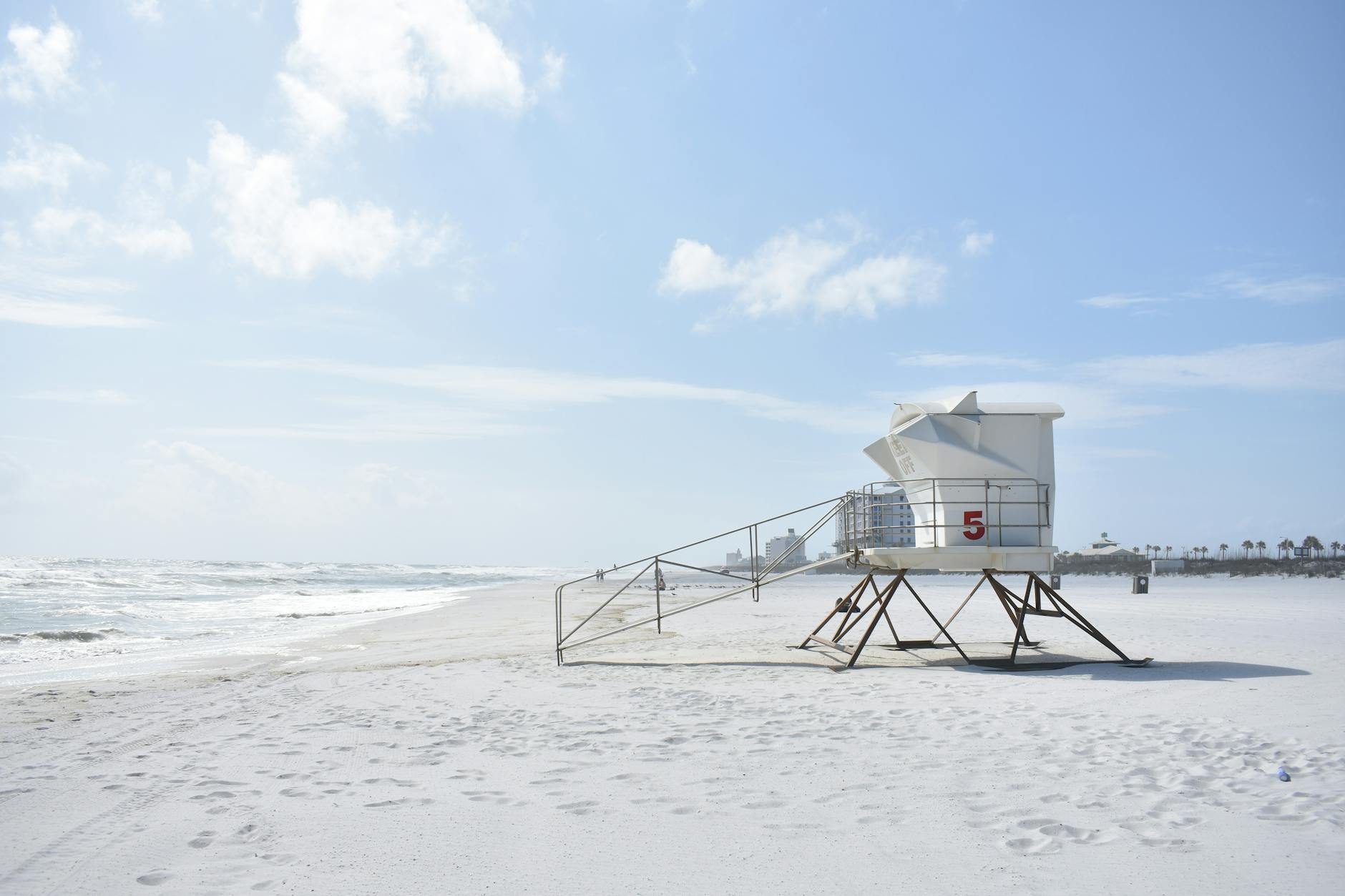 photography of white lifeguard house on beach resort