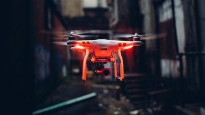flying uav with red lamps in grunge yard