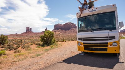 couple sitting on top of the rv