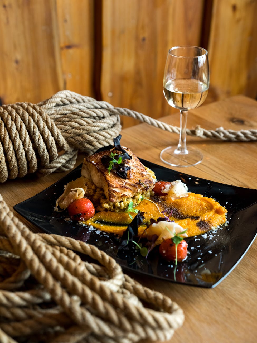 plate with dessert served with glass of white wine