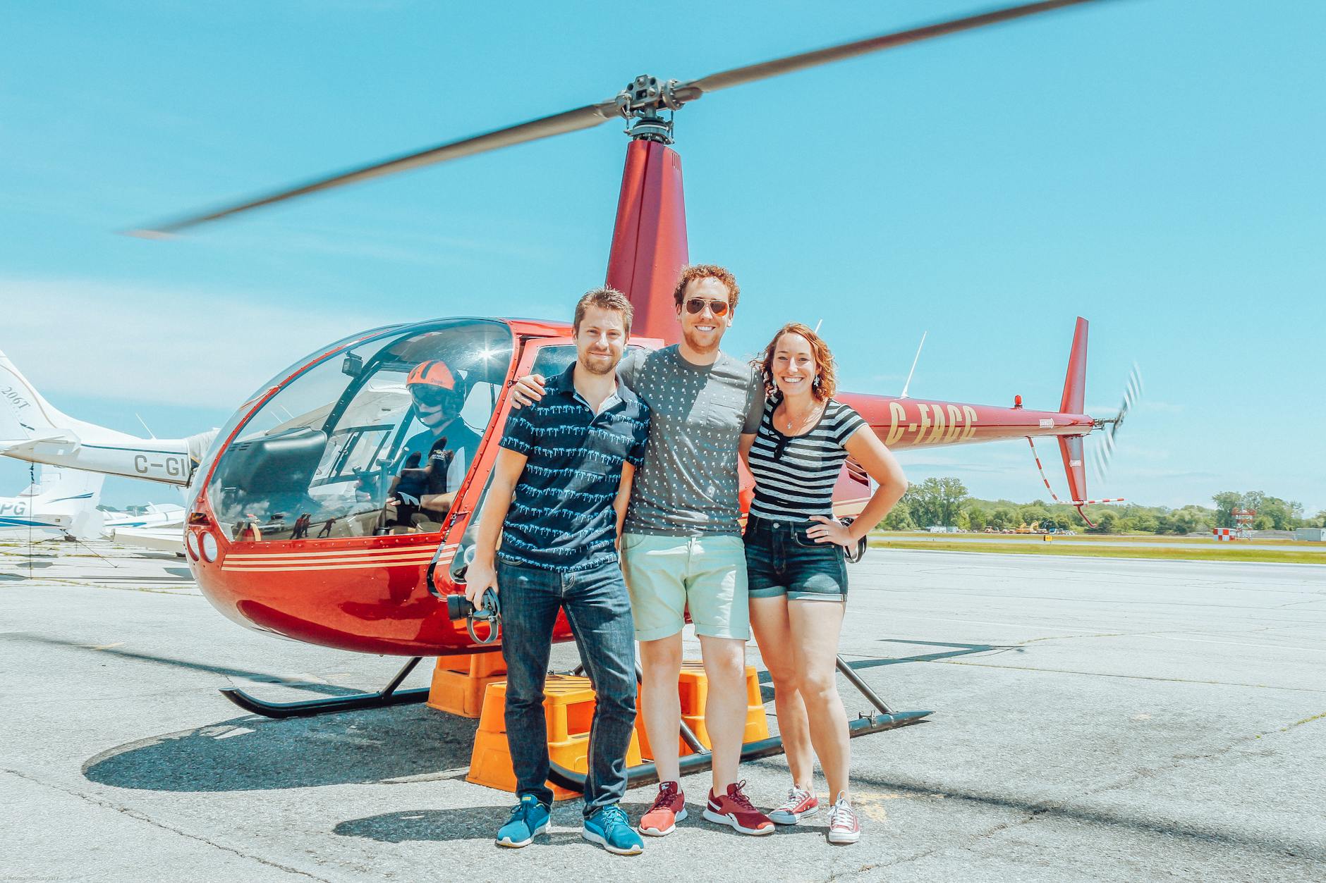 joyful friends bonding near modern helicopter