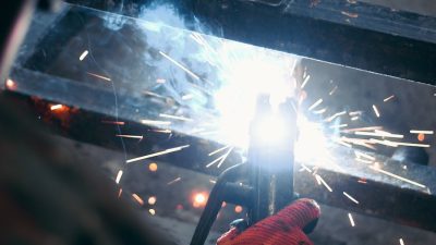 a person welding iron bars together