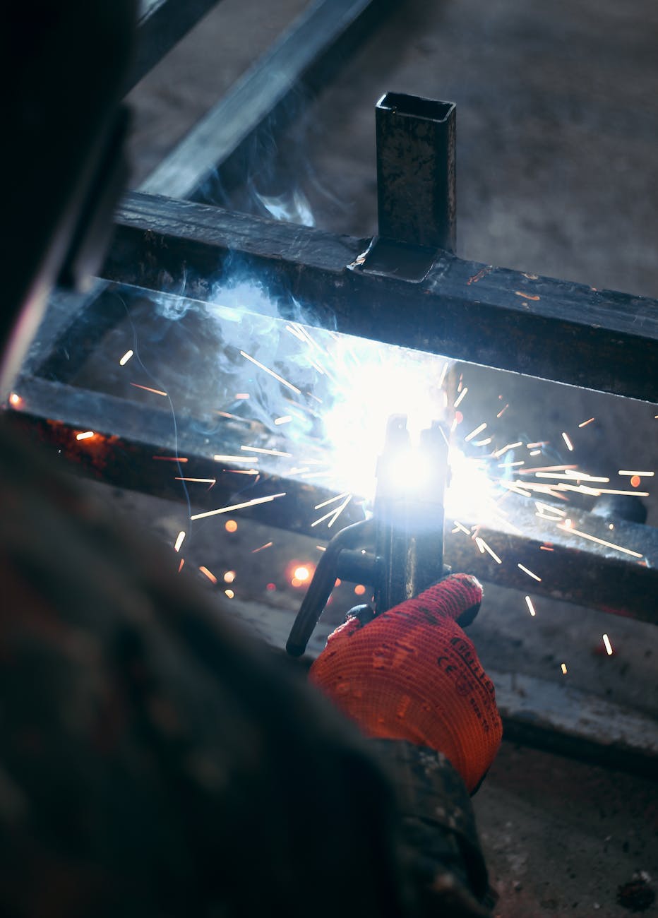 a person welding iron bars together