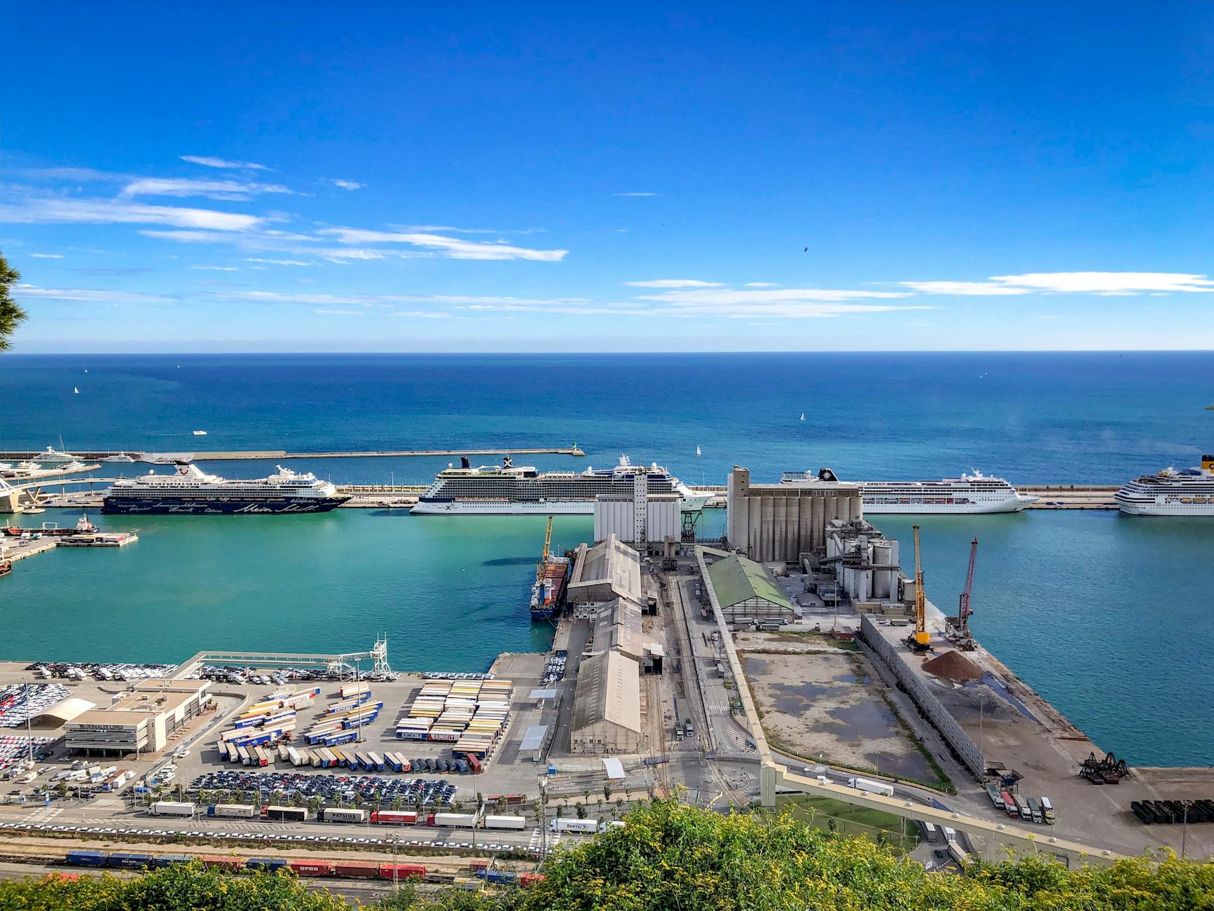 modern port with moored ships near endless sea
