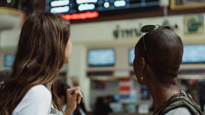 tourists at flight timetable