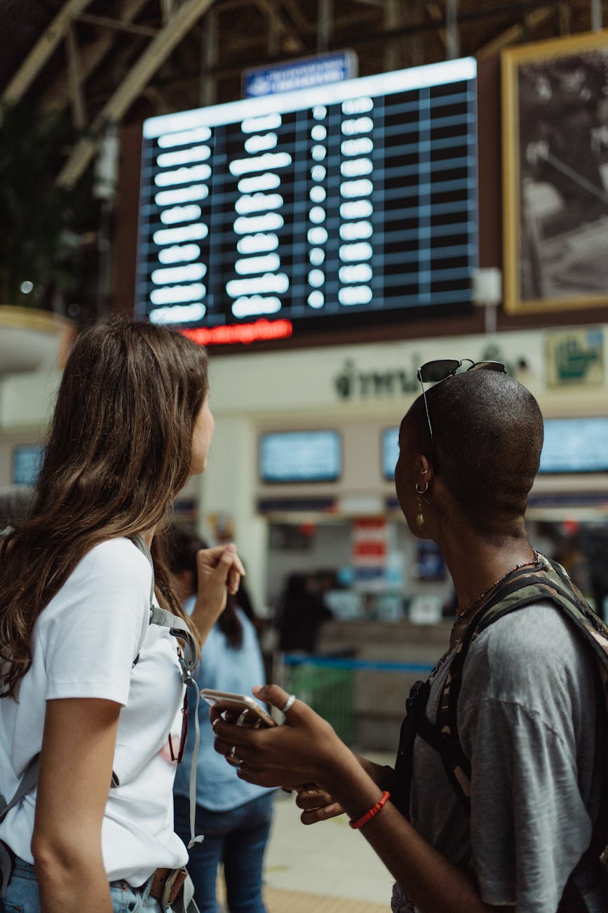 tourists at flight timetable