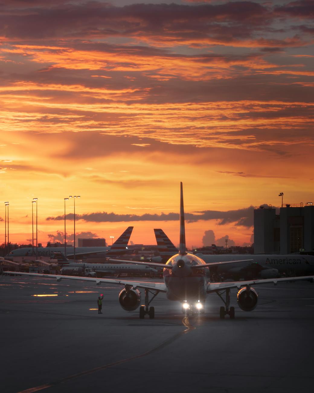 airplanes on tarmac during sunset