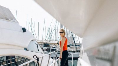 a woman in orange tank top and black pants