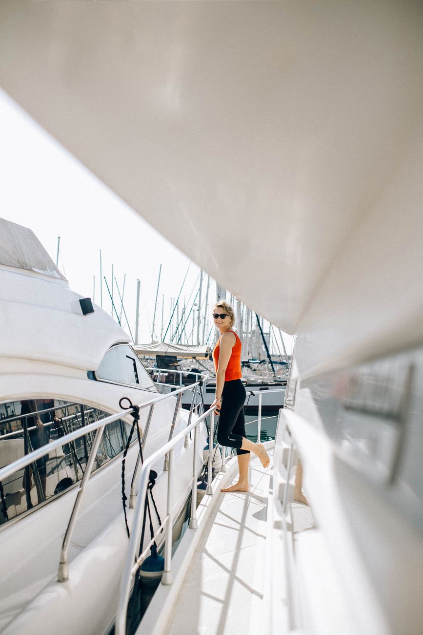 a woman in orange tank top and black pants