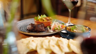 a meal and red wine served at a restaurant