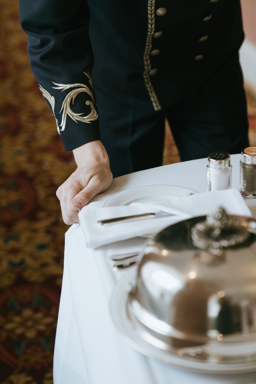 bellboy pulling a serving tray