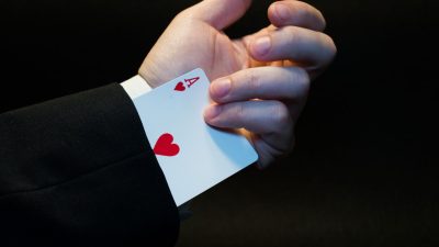 person holding ace of heart playing card