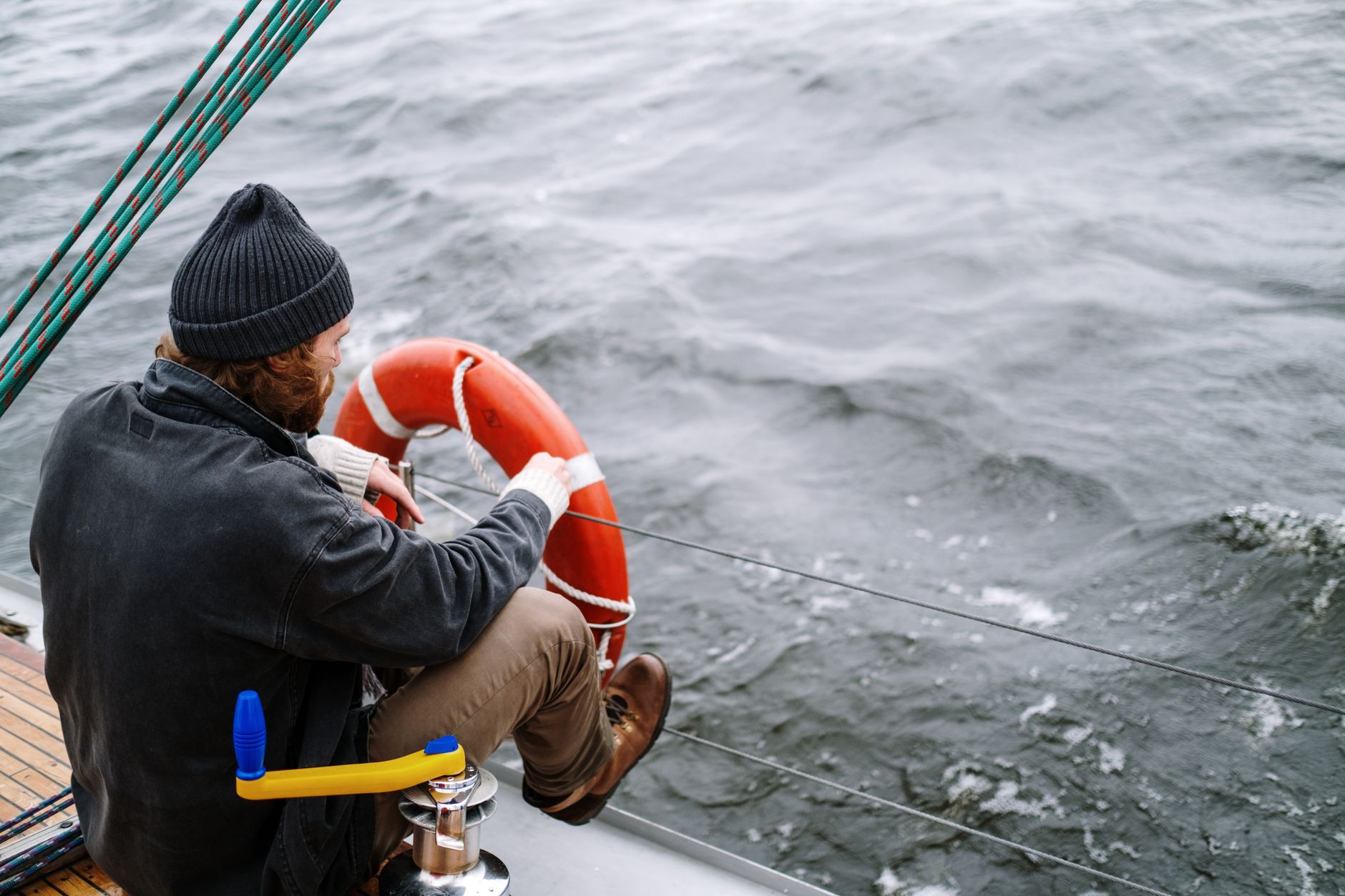sailor resting on deck looking at the sea