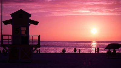 silhouette of people on the beach during sunset