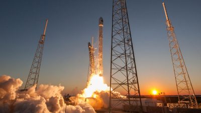 spacecraft launching into orbit during sundown