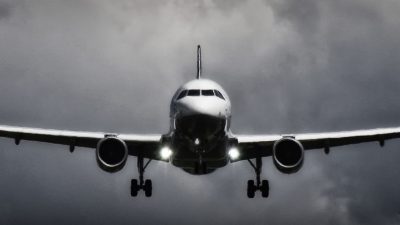 in flight airliner in grayscale photo