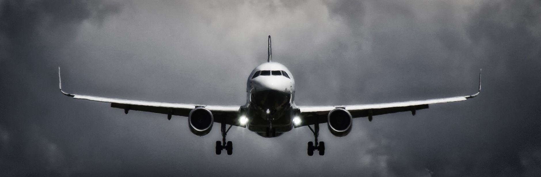 in flight airliner in grayscale photo