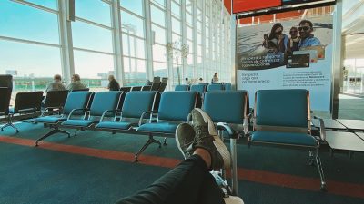 man waiting for flight in airport